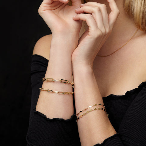14k Yellow Gold Paper Clip Chain Bracelet on woman's arm