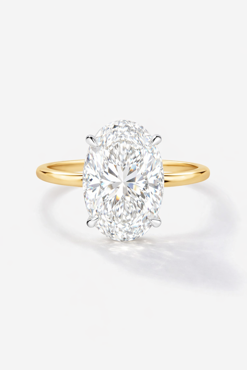 Gold ring with a large diamond on a white background