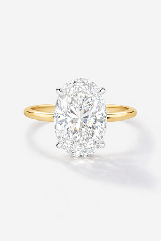 Gold ring with a large diamond on a white background