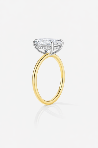 Gold ring with a diamond on a white background
