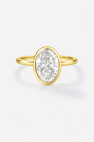 Gold ring with a large diamond on a white background