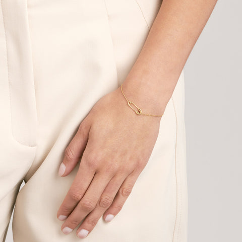 14k Yellow Gold Safety Pin Bracelet on woman's wrist