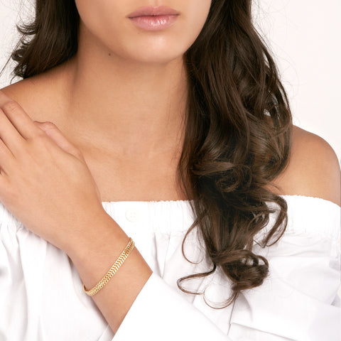 14k Yellow Gold Hollow Bismark Chain Bracelet on woman's wrist