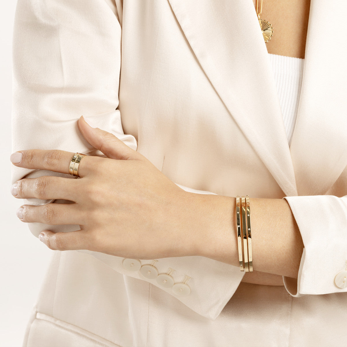 14K Yellow Gold Bezel Diamond Bangle Bracelet on woman's wrist