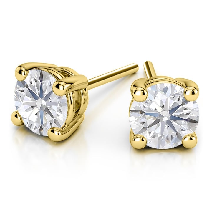 A pair of yellow gold earrings with a round diamond