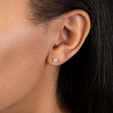 A pair of classic diamond stud earrings in white gold featuring lab-created diamonds on ear