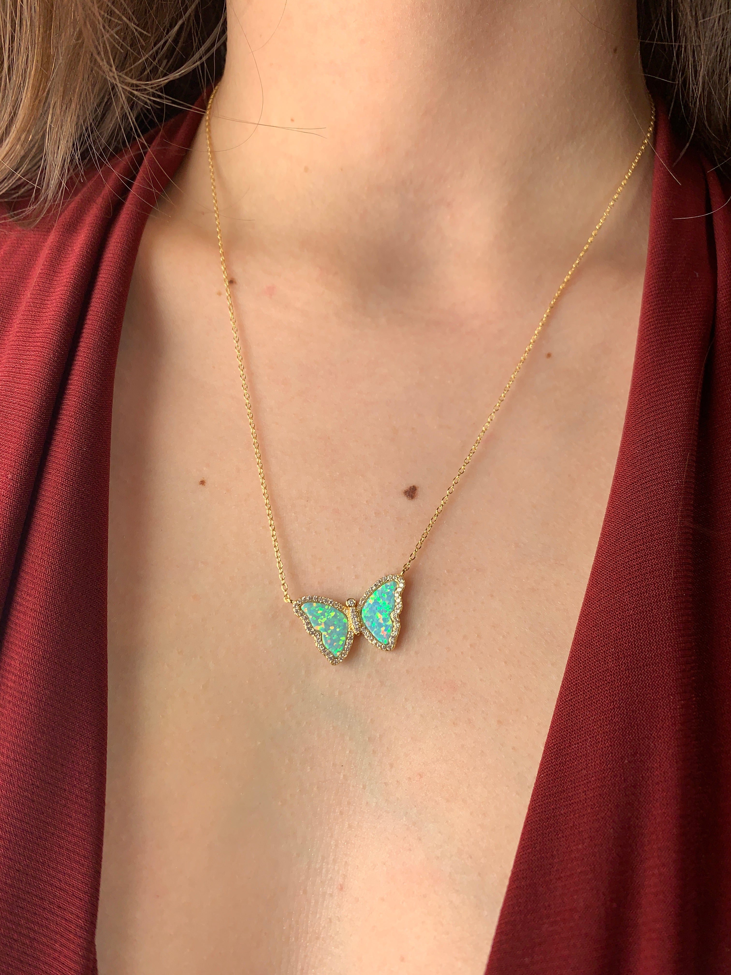 14k Yellow Gold Opal Butterfly Necklace on woman's neck