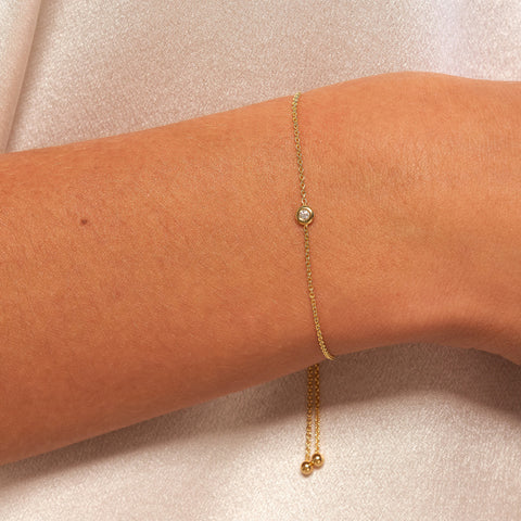 14k Yellow Gold Petite Diamond Bezel Bolo Bracelet on woman's wrist